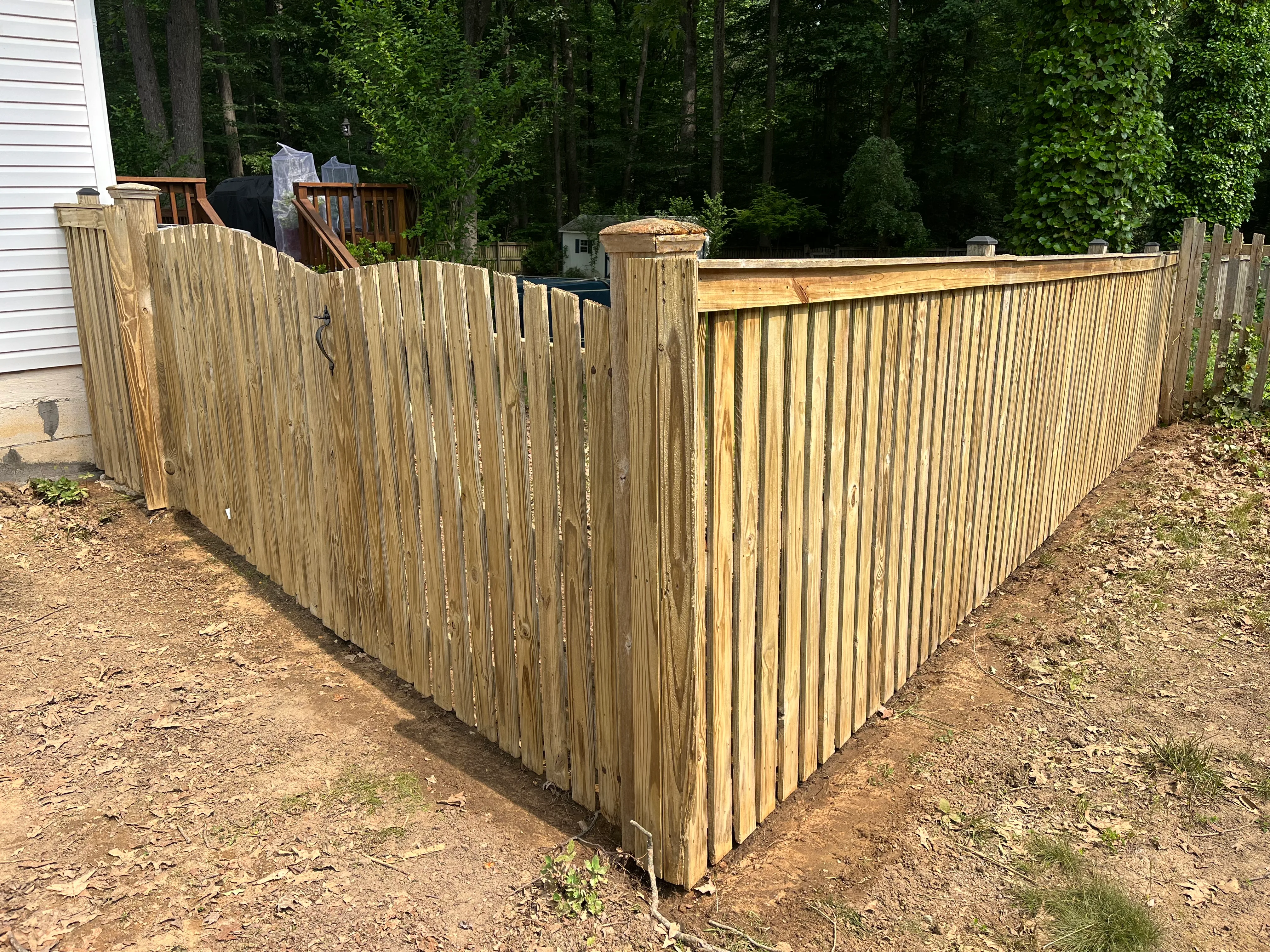 Wood fence after cleaning and restoration — natural wood color returned