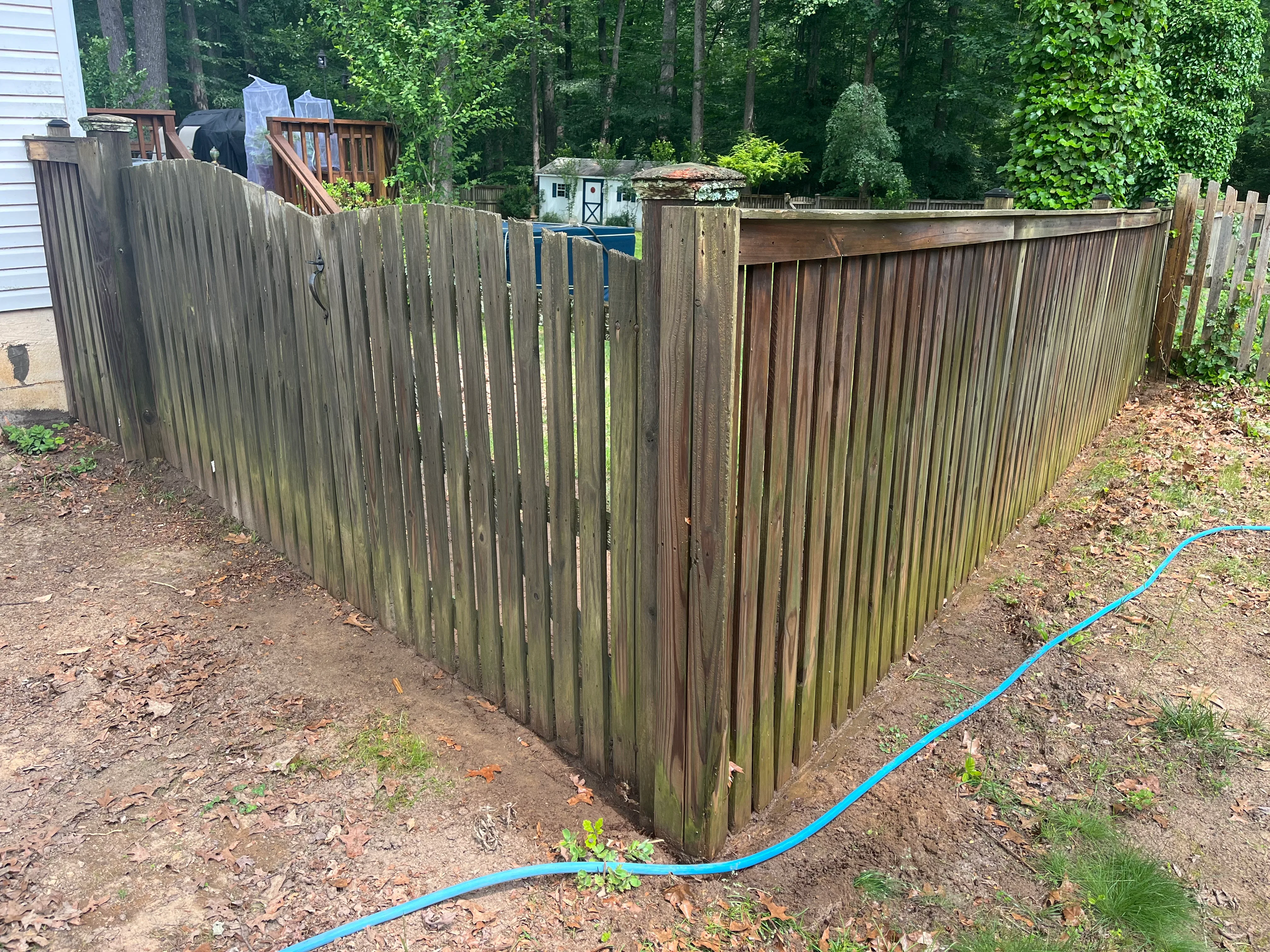 Wood fence before cleaning — grey oxidation and surface buildup