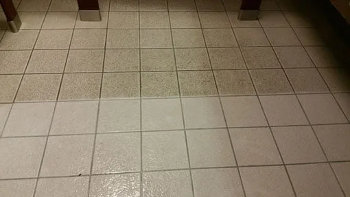 Living room tile and grout before and after cleaning — stained grout lines restored