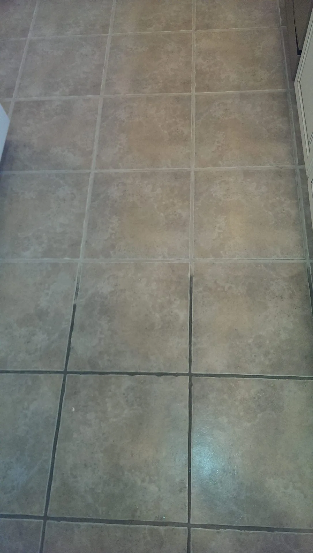 Tile floor in Nocona, TX — dark grout lines before cleaning restoration